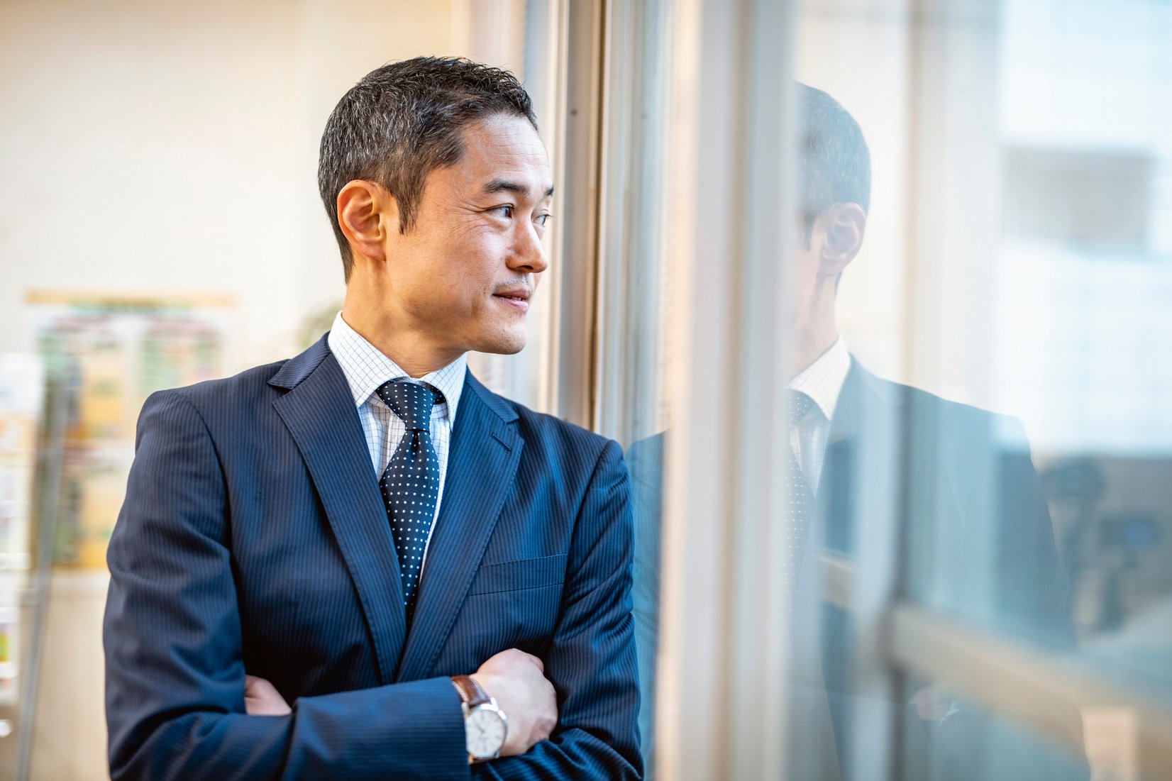 Male Japanese Hospital Administrator Standing at Window